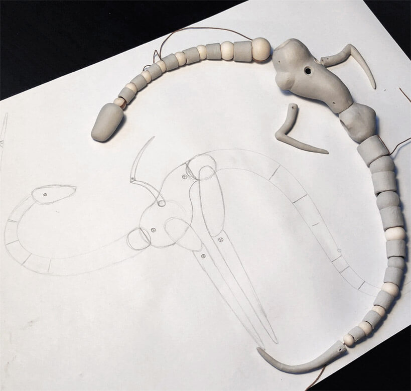 photo of the blueprint of the doll and a half-made dragon doll