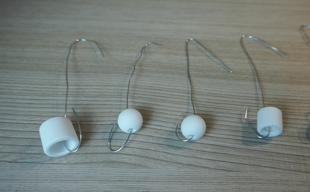 test doll pieces attached to a wire
