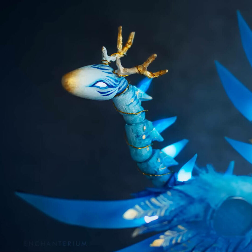 Close up of a blue ice dragon BJD customization.